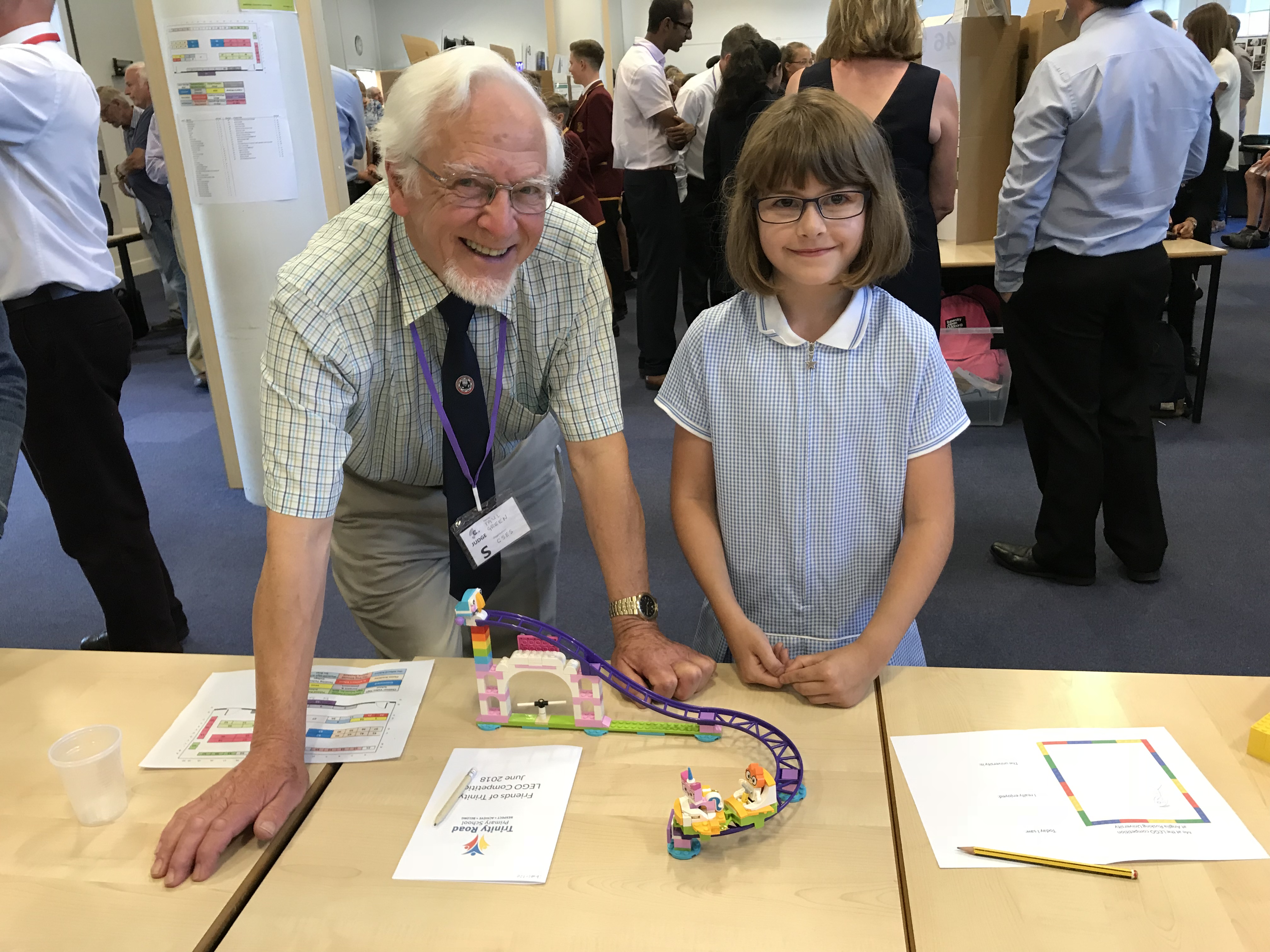 Competition judge Paul Green speaks with primary school pupil Charlotte