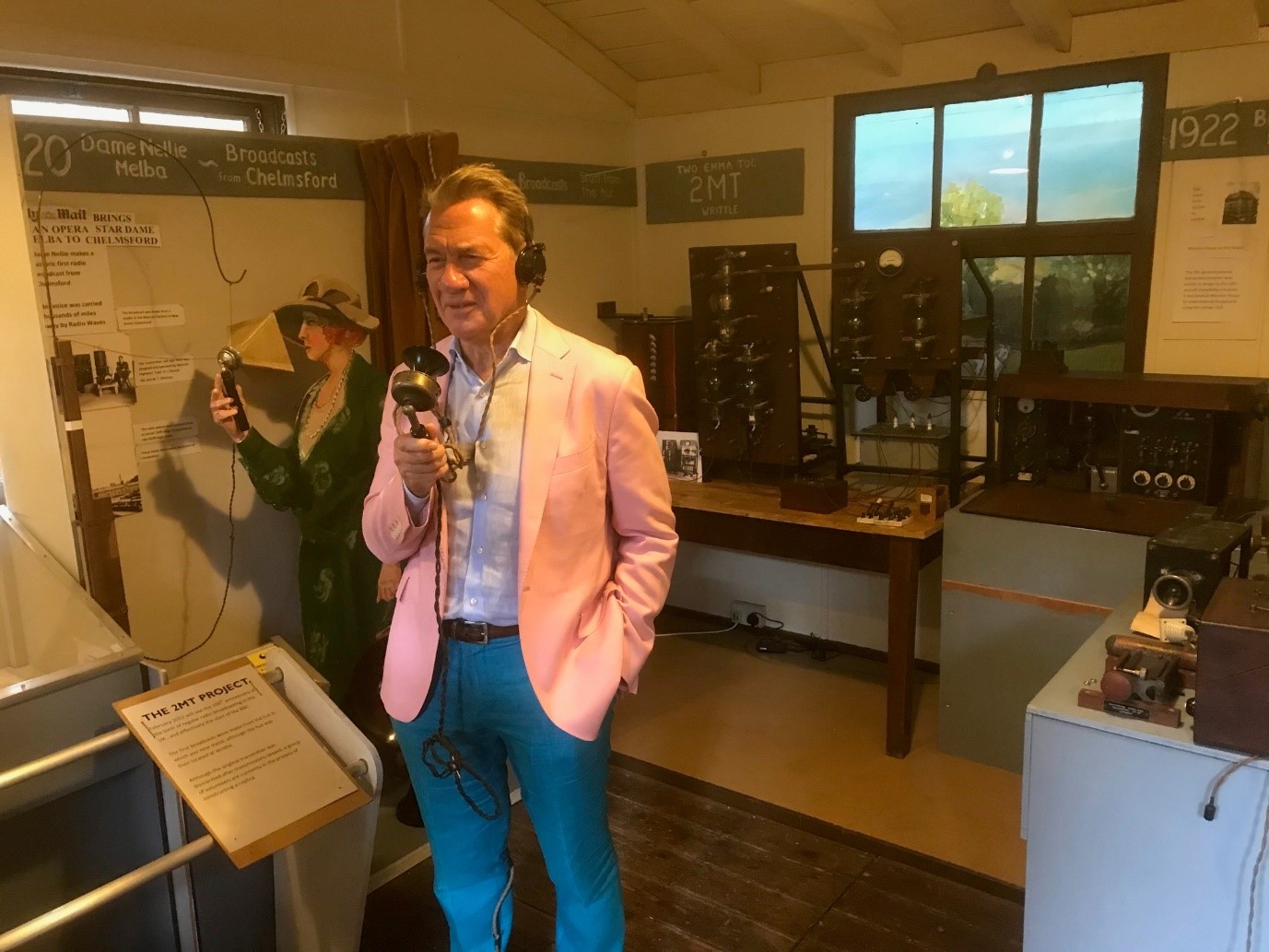 Great British Railway Journeys presenter Michael Portillo trying out an original microphone in the Writtle Hut.